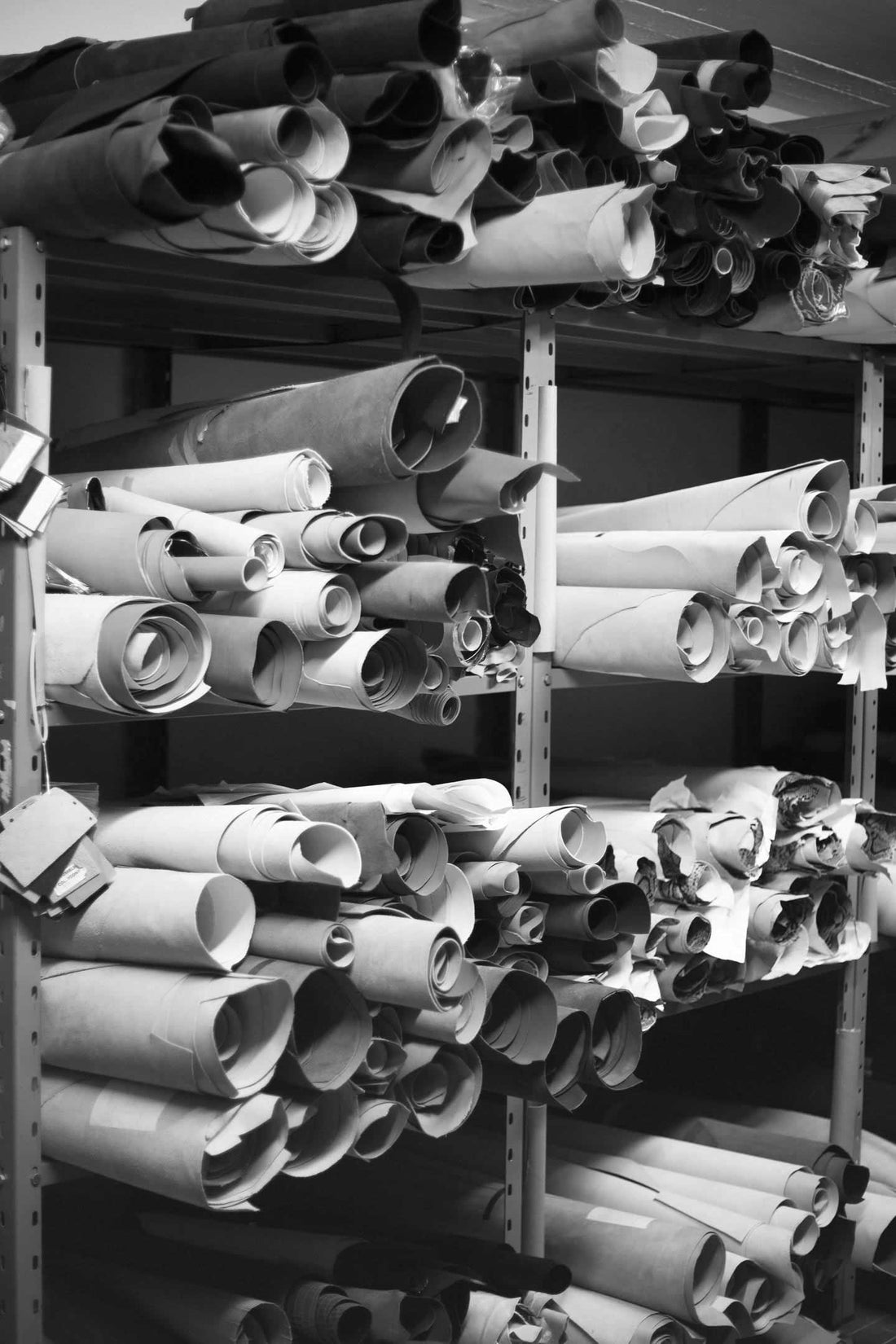 Different quality leather stocked in tannery in black and white. 